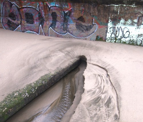 Water coming in from land on ocean beach